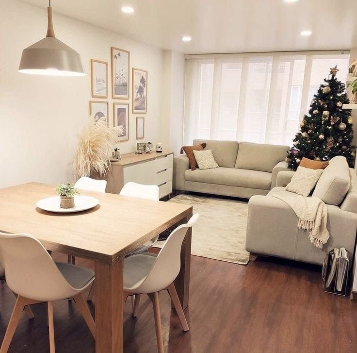 a living room filled with furniture and a christmas tree in the middle of the room