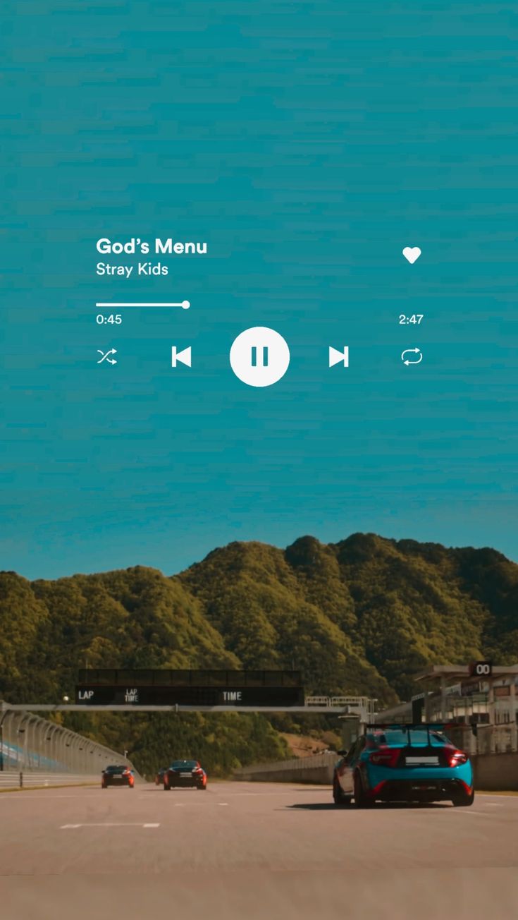 a car driving down a road next to green trees and hills with the words god's menu on it