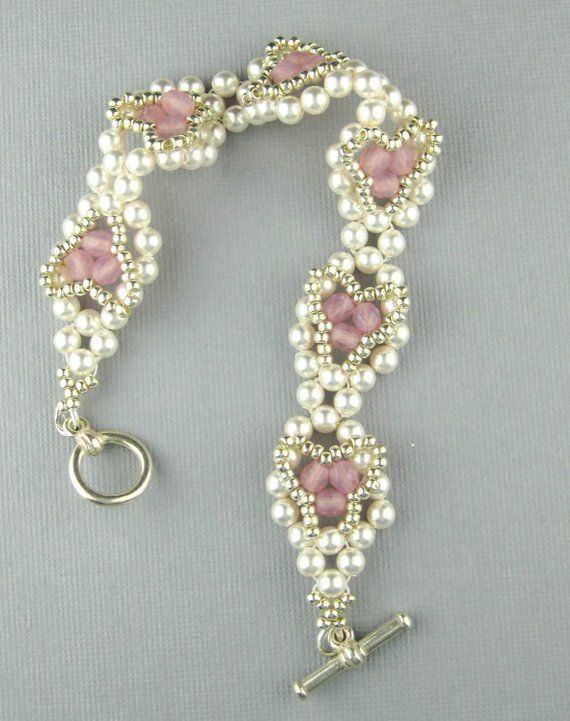 a bracelet with pearls and pink stones on the end is shown in an instagramtion