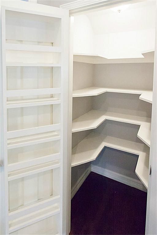 an empty white closet with shelves in it