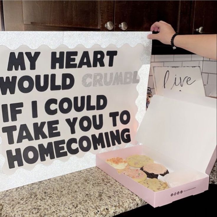 someone holding up a sign that says, my heart would crumb if i could take you to home coming