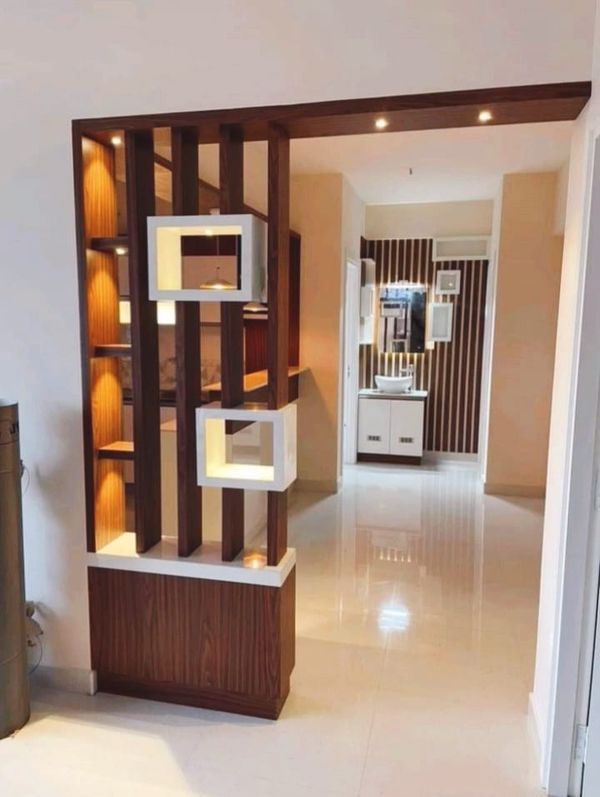 the interior of a modern home with white and wood accents, including shelves that have lights on them