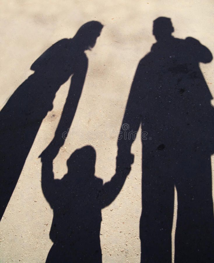 the shadow of two people holding hands in front of a cement wall royalty images and clippings