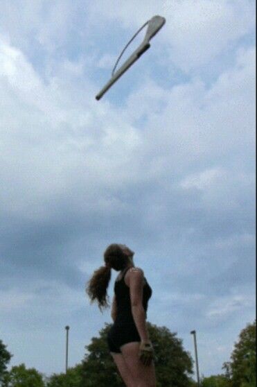 a woman is flying a kite in the sky