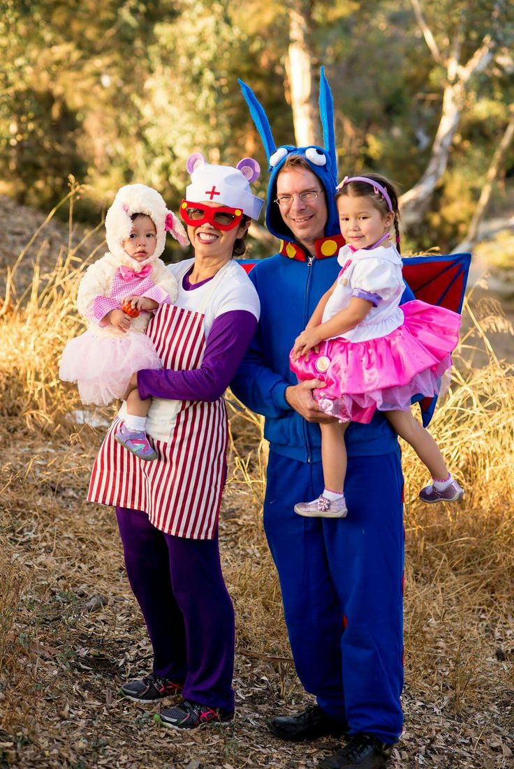 two adults and one child dressed up in costumes