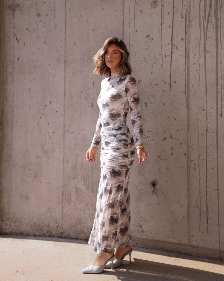 Feel elegant and flirty in our Endearing Elegance Dress. This long sleeve dress features a grey floral pattern, perfect for any fancy occasion. The flattering fit is sure to make you feel confident and beautiful. Get ready to turn heads! Fabric 95% polyester, 5% spandex Lining 100% polyester zipper in back Feminine Long Sleeve Ruched Maxi Dress, Elegant Floral Print Maxi Dress For Date Night, Fitted Floral Dress For Fall Party, Elegant Long Sleeve Maxi Dress With Floral Print, Fall Party Long Sleeve Floral Dress, Elegant Fitted Floral Dress For Date Night, Floral Print Maxi Long Sleeve Dress For Party, Floral Print Maxi Long Sleeve Party Dress, Floral Print Maxi Length Long Sleeve Party Dress