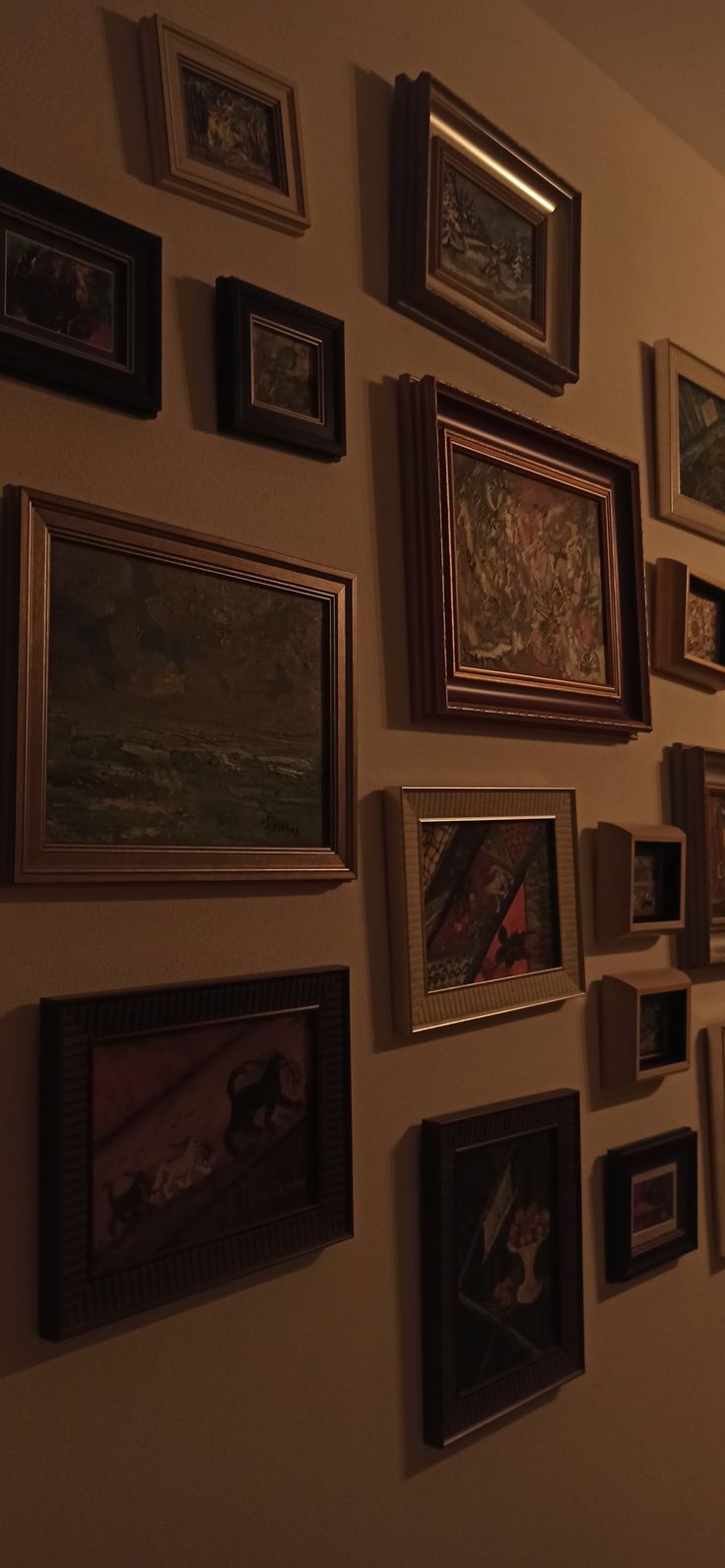 there are many framed pictures on the wall