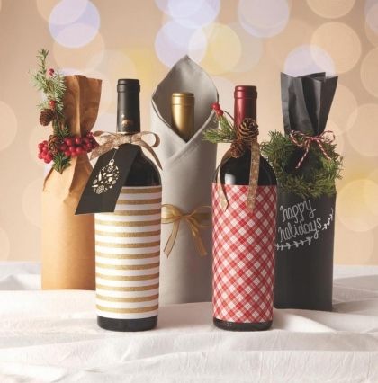 three wine bottles wrapped in paper and tied with twine