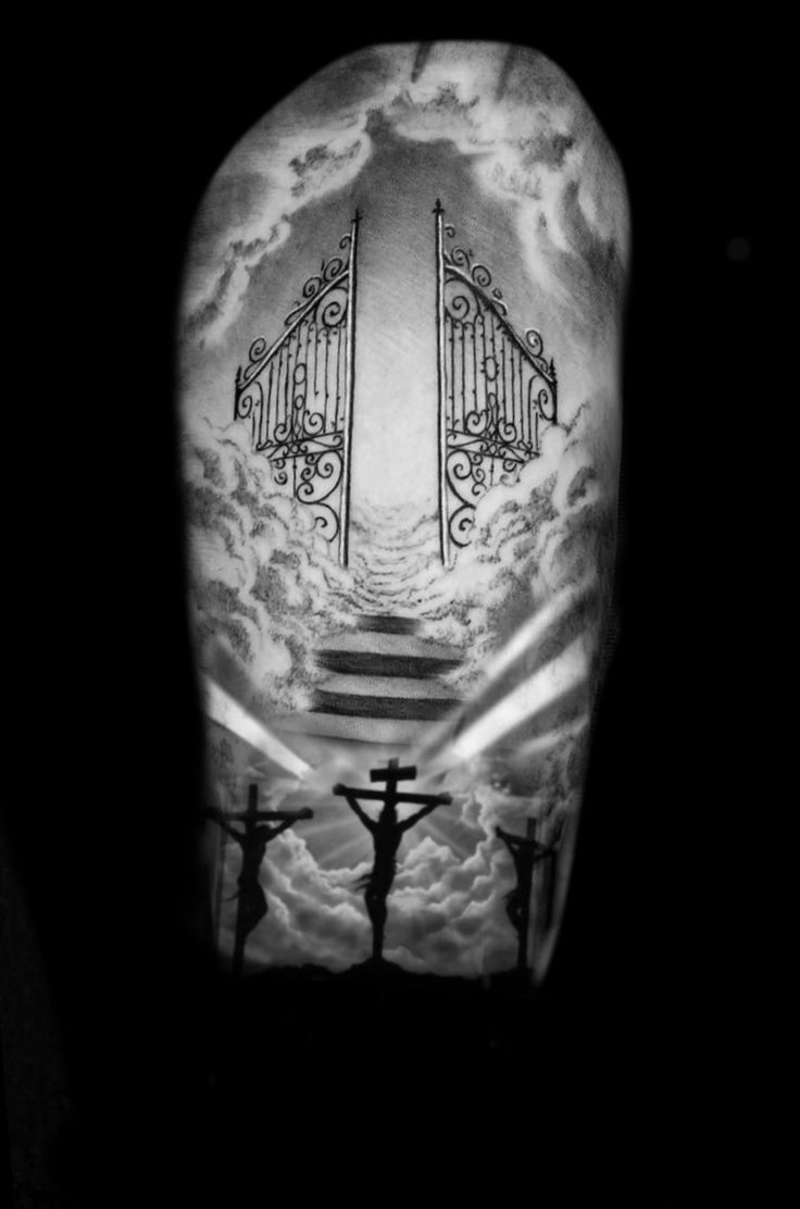 a man's arm with a cross and gate on it, in black and white