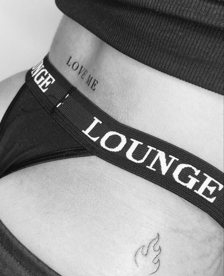 black and white photograph of a woman's stomach with the words lounge on it