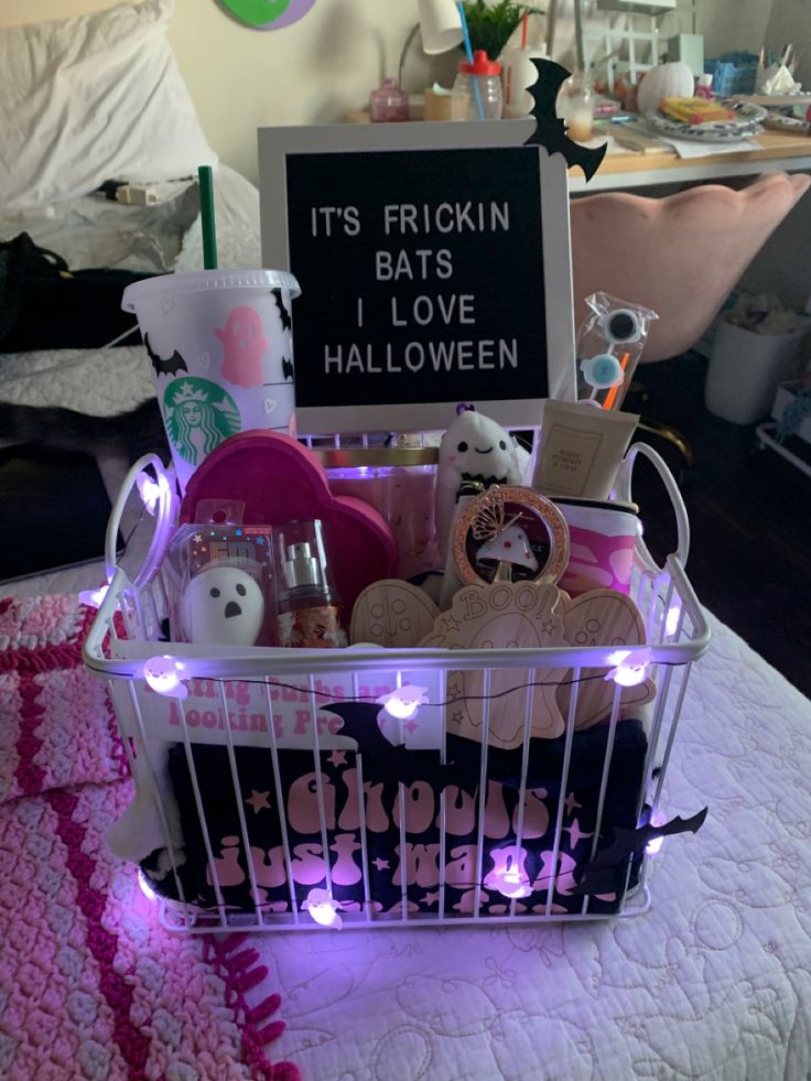 a basket filled with lots of items sitting on top of a white table covered in pink lights