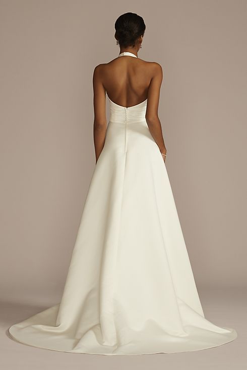 a woman in a white wedding dress looking back