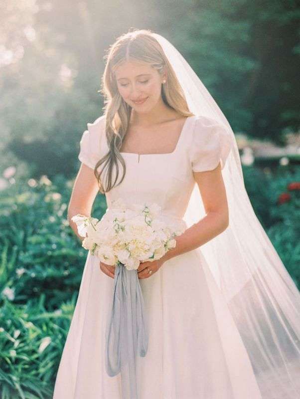 a woman in a wedding dress holding a bouquet