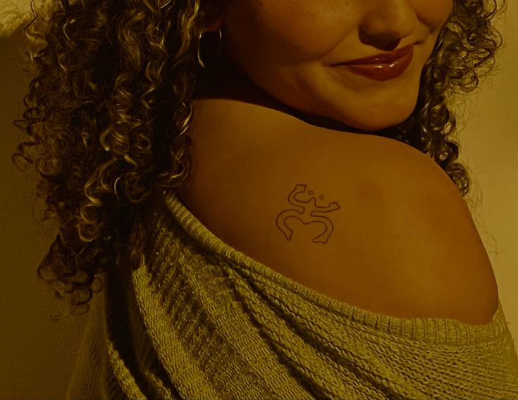 a woman with a tattoo on her shoulder