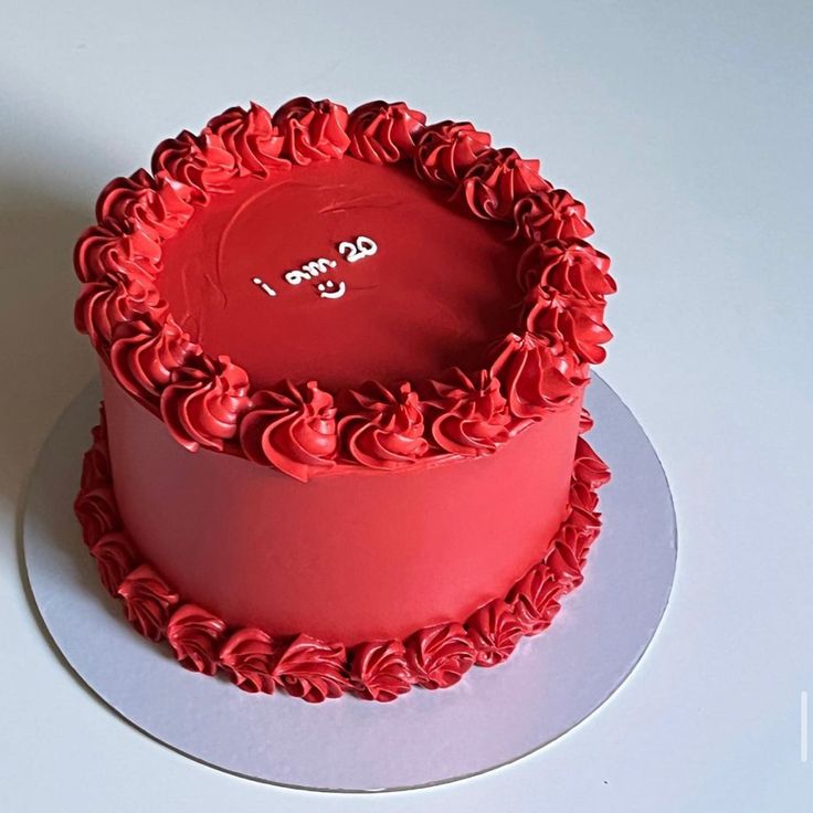 a red cake sitting on top of a white plate