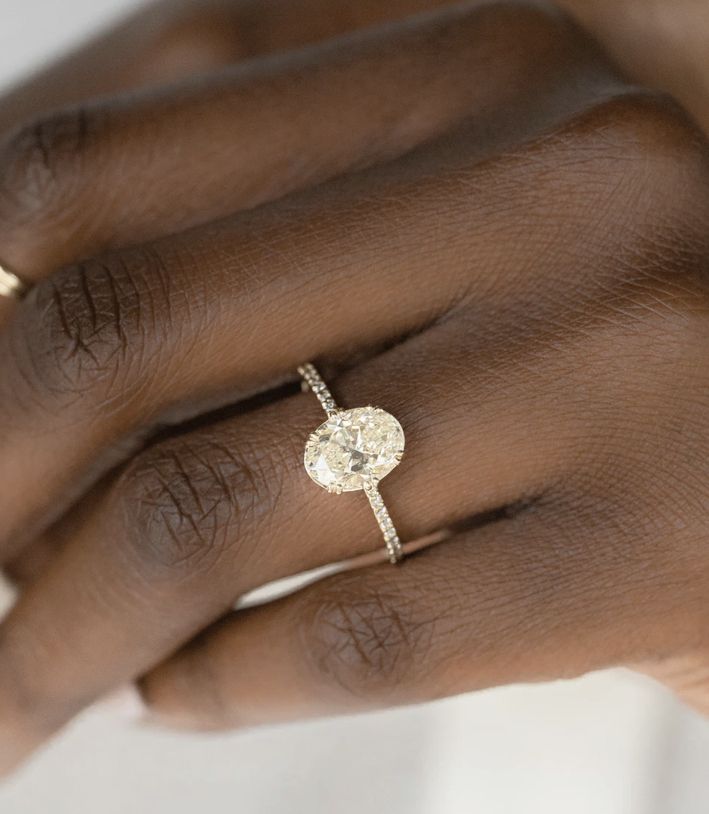 a woman's hand with a diamond ring on it