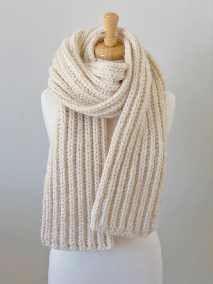 a white knitted scarf on a mannequin