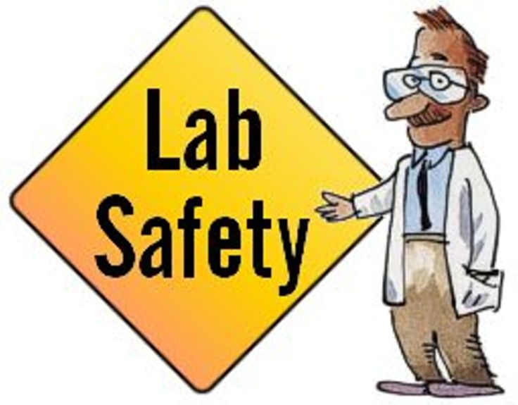 a man pointing to a lab safety sign