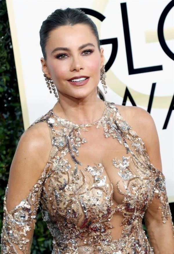 an image of a woman in a dress at the golden globe award red carpet with her hands on her hips