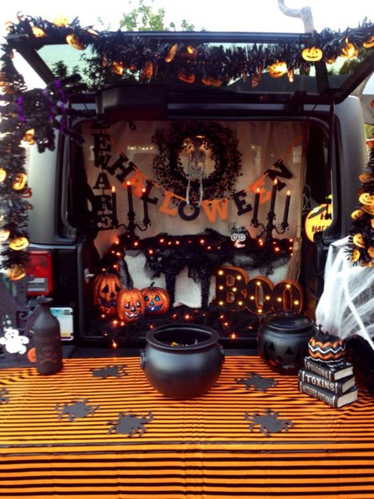 the back of a van decorated for halloween with pumpkins and jack - o'- lanterns