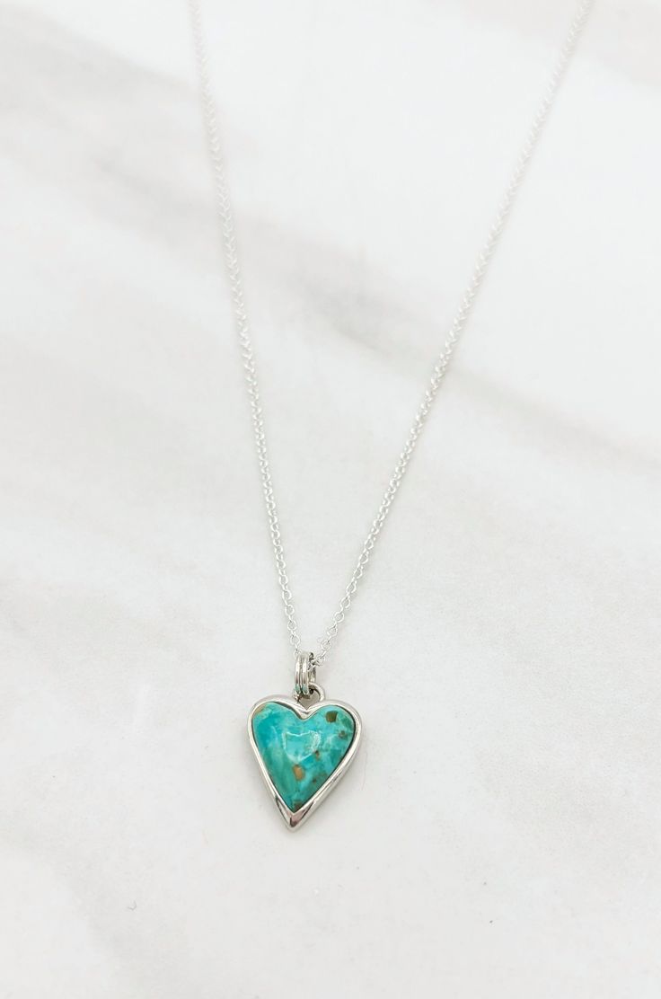 Treat yourself to a little extra sparkle with this beautiful Turquoise and Silver Heart Necklace. Featuring a striking turquoise heart shaped pendant with a glittering silver trim, this look is sure to become your go-to for everyday glam. Love it 'til your heart's content!Details: Handmade Turquoise Heart Pendant Sterling Silver Chain Approximate Dimensions: Length: 17.5" Heart Pendant: 0.5" x 0.5" Turquoise Heart-shaped Necklaces For Gifts, Turquoise Heart Necklaces For Gift, Turquoise Heart-shaped Necklace For Gift, Turquoise Heart Necklace For Gift, Turquoise Heart Necklace With Heart Beads, Turquoise Heart Charm Jewelry, Turquoise Sterling Silver Heart Pendant Necklace, Turquoise Heart Pendant Necklace In Sterling Silver, Turquoise Heart Charm Pendant Necklace