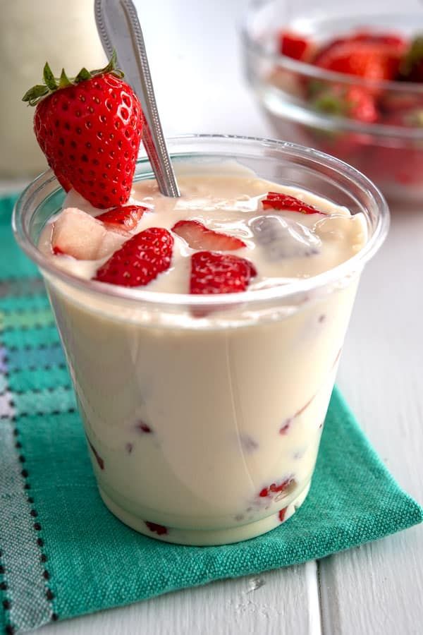 a dessert in a glass with strawberries on top