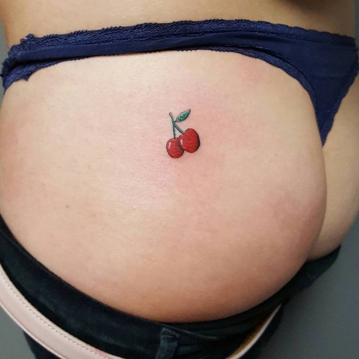 a small cherry tattoo on the stomach