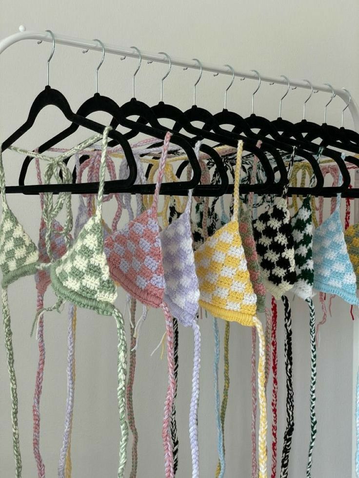 a rack with many different colored ties hanging from it's hooks and hangers