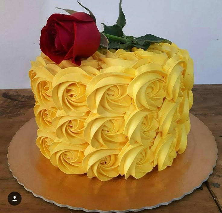 there is a yellow cake with roses on it