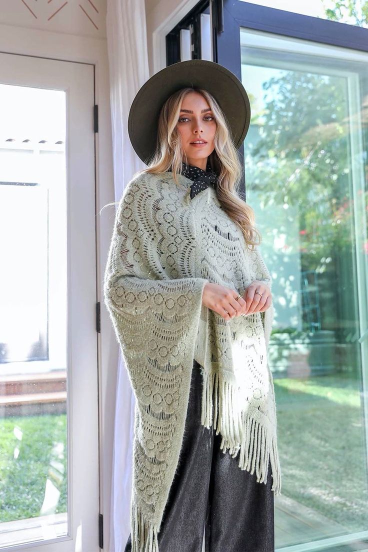 **This product is shipped by a third party warehouse within the US and may arrive separately from your complete order. This is the perfect poncho for a chilly day! The soft, cozy fabric will keep you warm while the cute scallop lace detail adds a touch of style. You'll love wearing this poncho with jeans and boots or dress it up with a skirt and heels. #lovemyleto Imported One Size Knit Poncho With Fringe, Cozy Poncho For Cold Weather, Winter Knit Shawl One Size, Cozy One Size Shawl Cape, Cozy One-size Shawl Cape, Cozy Shawl In Cape Style One Size, Long Sleeve Fringe Poncho, Winter Knit Sweater With Lace Trim, Cozy Winter Cape Shawl