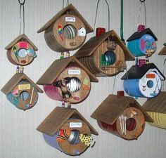 a bunch of bird houses hanging on the wall