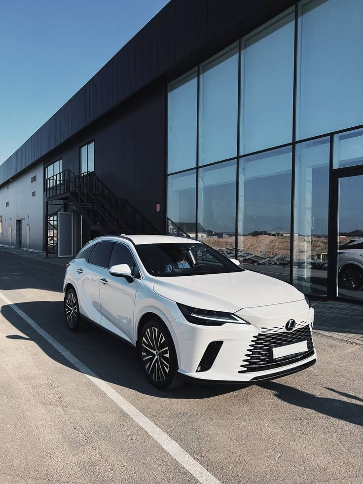 a white car parked in front of a building