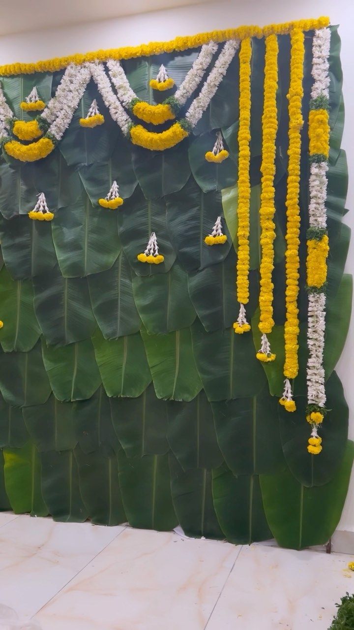 a green wall with yellow and white decorations on it's sides, hanging from the ceiling