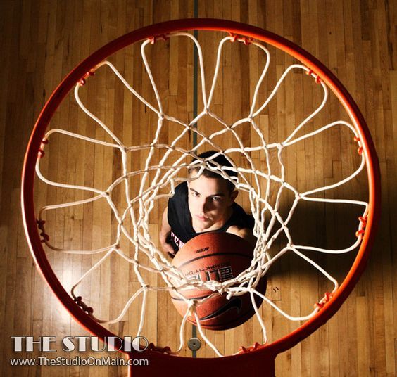 a man is playing basketball in the hoop