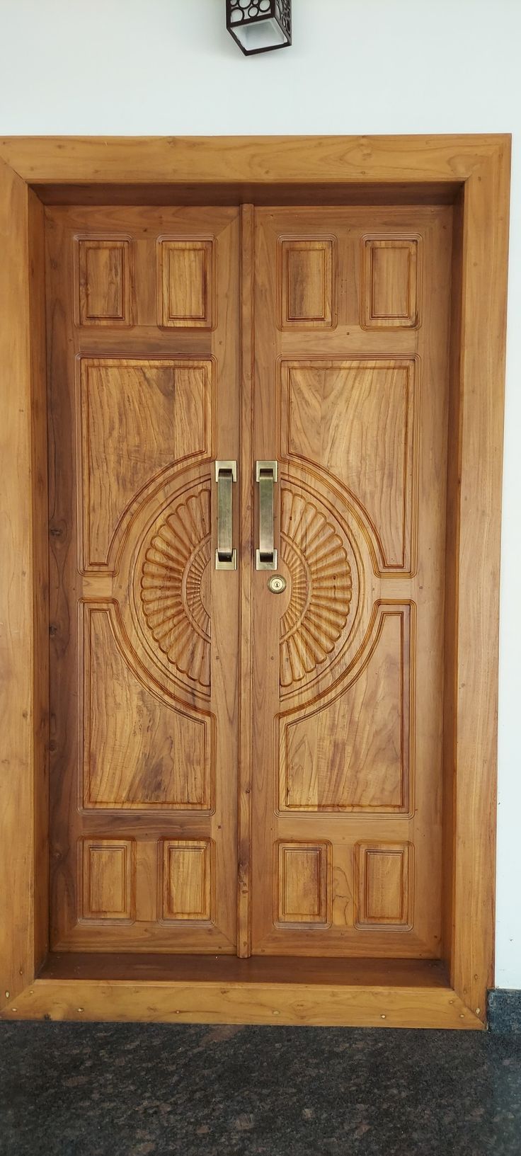 a wooden door with two metal handles on the front and side doors to both sides