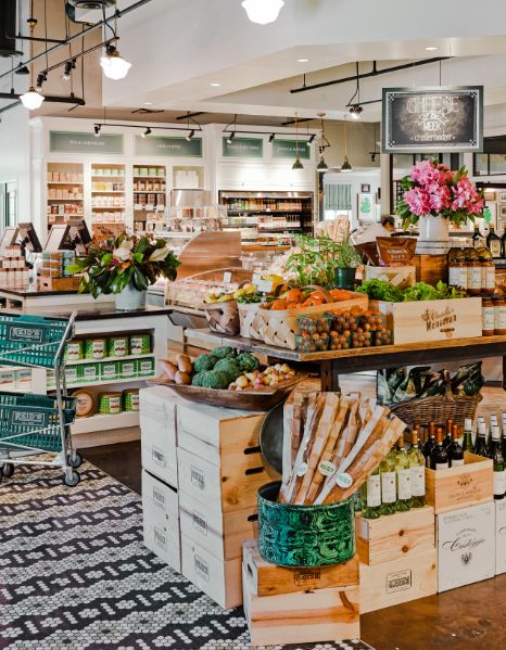 a grocery store filled with lots of fresh fruits and vegetables next to boxes of produce