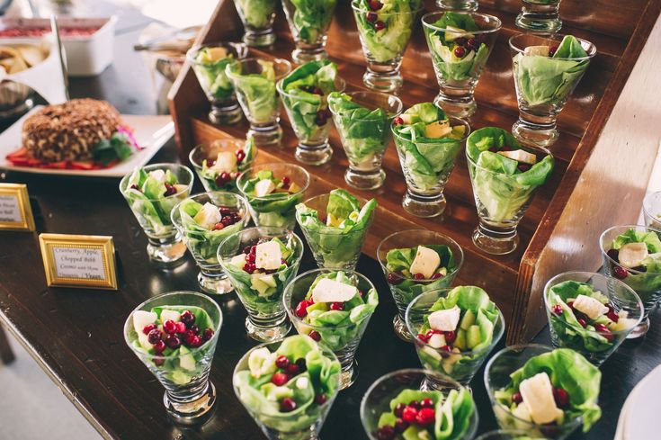 many small glasses filled with food on top of a table