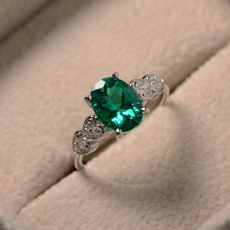 This ring features a 7*9mm oval cut lab grown emerald and sterling silver finished with rhodium. Customization is available. It is made by hand, and it will take about 7 days to finish the ring after your payment is completed. Main stone: lab emerald Main stone weight: Approx 1.75 ct Metal type: sterling silver finished with rhodium Accent stone: cz Customization is available, I also can make it with 14k solid gold (white or yellow or rose) and diamond accent stone, just feel free to contact me. Aesthetic Engagement Ring, Slytherin Jewelry, Engagement Ring Non Traditional, Necklace Women Gold, Women Gold Chain, Aesthetic Engagement, Nontraditional Engagement Rings, Moissanite Engagement Ring White Gold, Inexpensive Jewelry