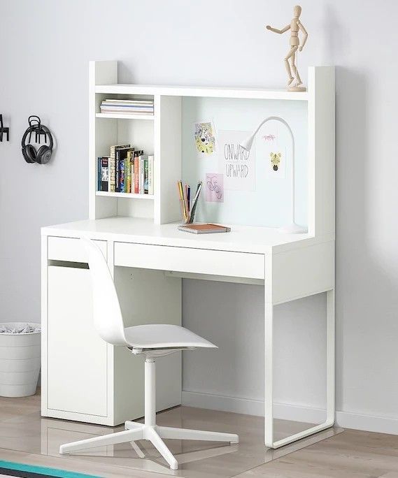 a white desk with a book shelf above it and a chair underneath the desk in front of it