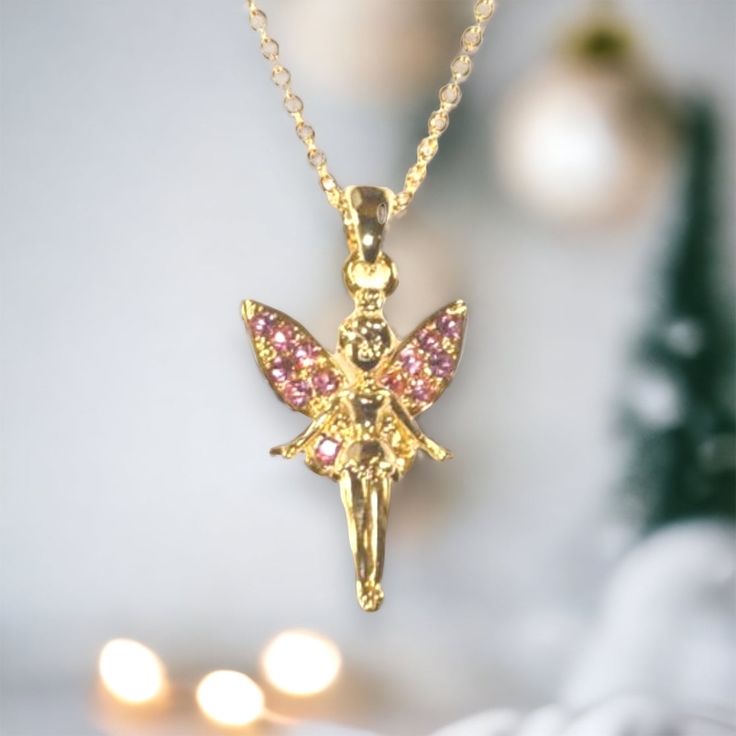 This fairy princess gold necklace is beautifully crafted with pink jewels on the wings. A fabulous gift idea. Gold chain. Suitable for children age 3 and over. Chain length 71/2 in. Fairycore Gold Necklaces For Party, Fairycore Gold Party Necklaces, Princess Style Gold Jewelry Gift, Gold Princess Style Jewelry For Gift, Princess Style Gold Jewelry For Gifts, Fairycore Gold Jewelry For Party, Princess Style Gold Jewelry For Party, Fairy Style Gold Jewelry For Gift, Gold Fairycore Jewelry Gift