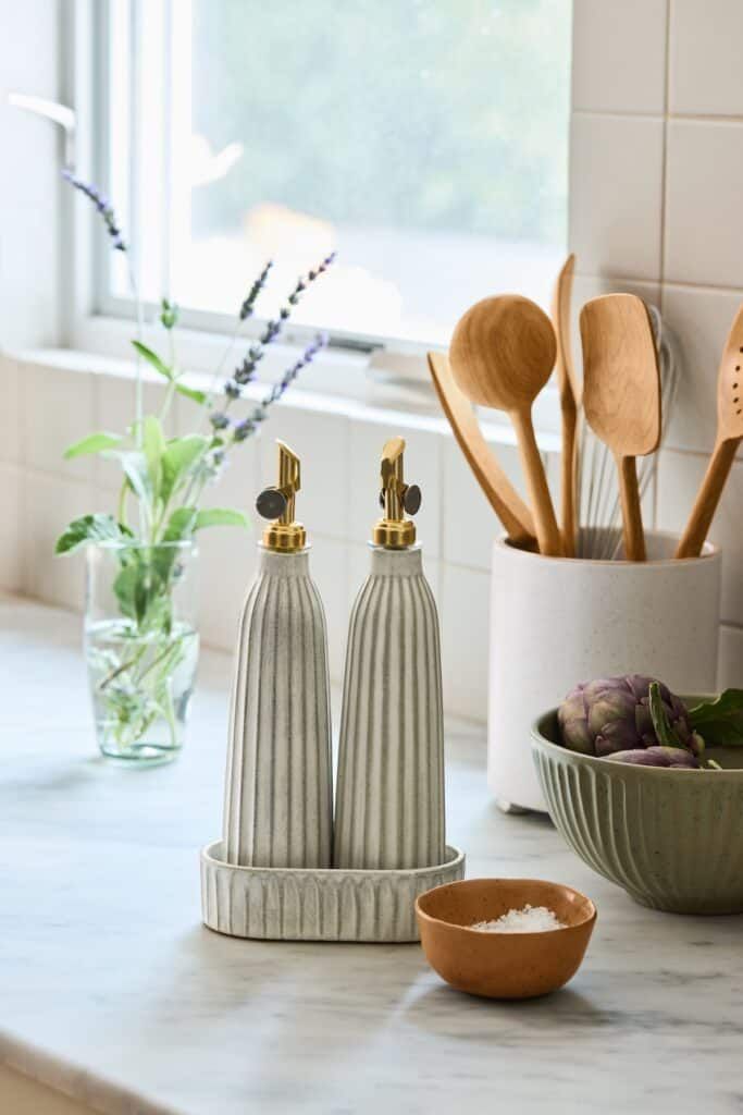 two salt and pepper shakers sitting on top of a counter next to a bowl