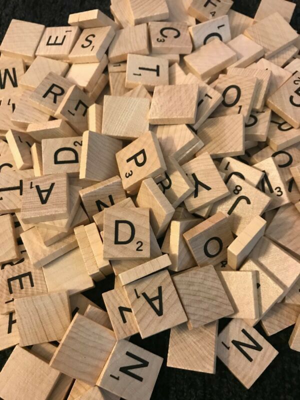 wooden scrabbles with letters and numbers on them