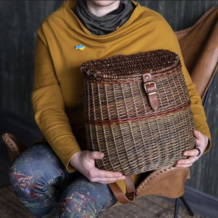 a woman holding a woven basket in her hands