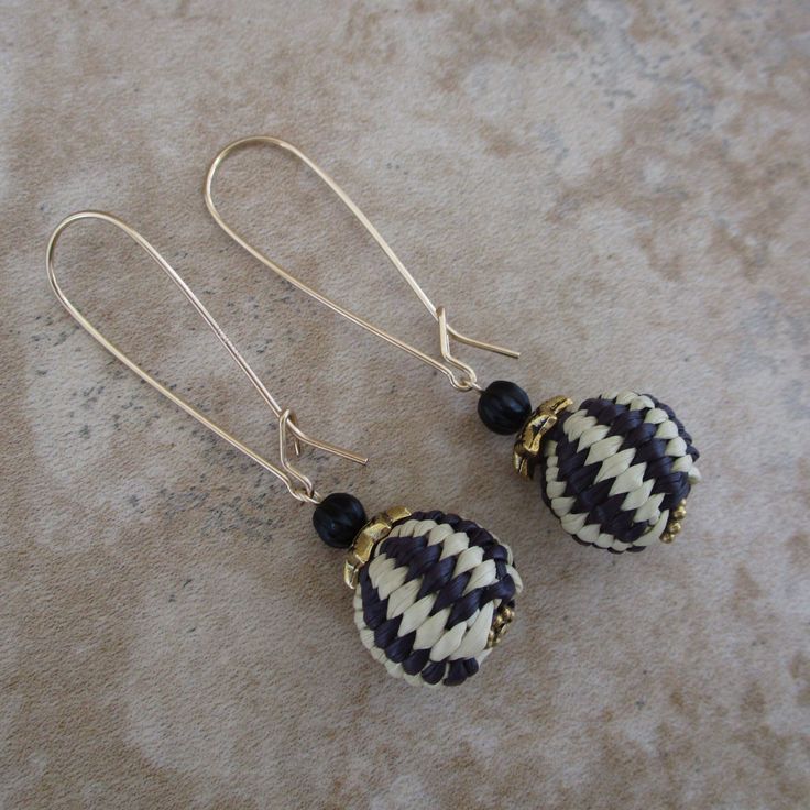 Eye-catching black and white woven balls of beauty dangle with these iraca earrings. Have fun with these natural fiber statement earrings. Iraca is lightweight. Iraca fiber - The balls are hand woven, and no two are exactly the same. Source: Fallen leaves from Iraca palm plants in South America. Color: Black and white Iraca ball measurements: .6 inch Earring length: 2.3 nches  Kidney ear wire (1.4 inches long): 14k gold-filled Elegant Handwoven Jewelry, Elegant Handwoven Natural Jewelry, Elegant White Handwoven Earrings, Elegant Woven Dangle Earrings, Elegant Woven Drop Earrings, Black Handwoven Artisan Earrings, Elegant Woven Dangle Jewelry, White Elegant Woven Jewelry, Elegant White Woven Jewelry