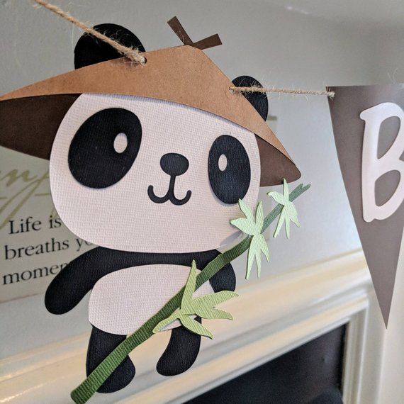 a paper panda bear hanging from a string