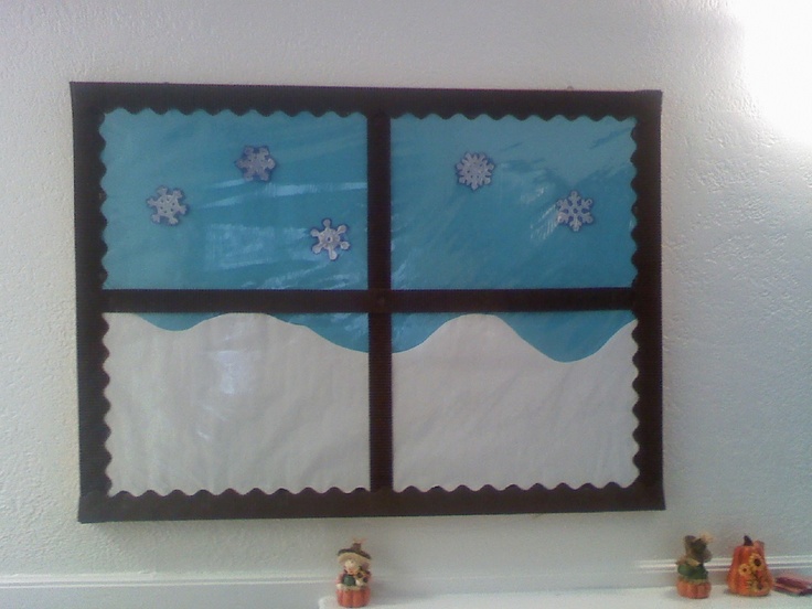 there is a window with snowmen on it in the wall above a sink and two small figurines