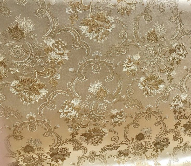 the gold and white wallpaper is very ornate