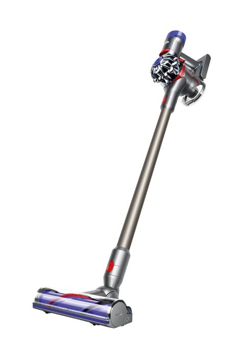 a silver and red vacuum cleaner on a white background with clippings to the side