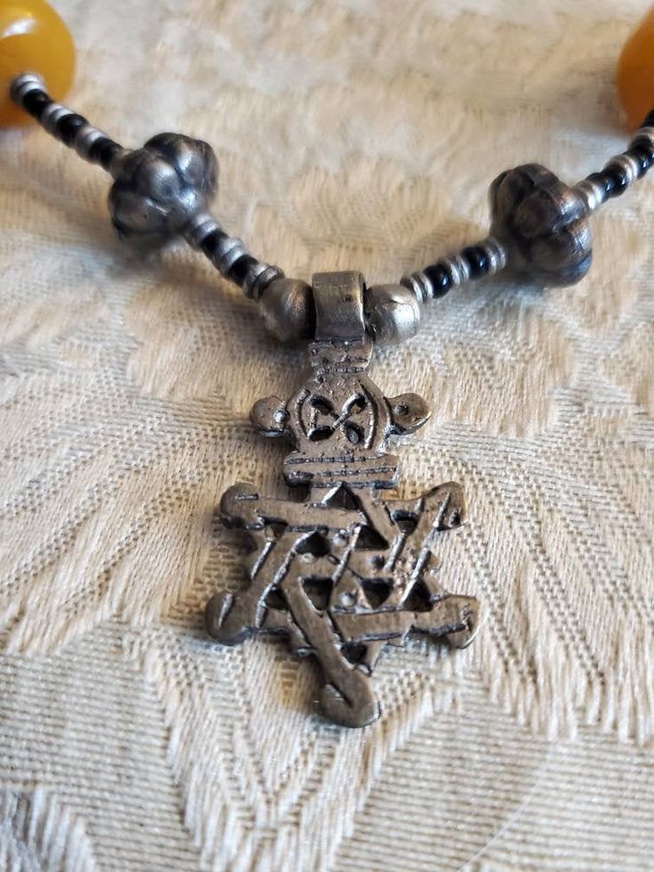 Vintage Ethiopian, Star of David, Cross 18 inch Necklace, Black , Silver Toned and Yellow Bead, Costume Jewelry, Fashion Accessory This is a nice find and very collectible. Very durable and strong. The pendant measures 1.50 inches tall and .75 inches wide. Check out our shop for monthly specials. We have a variety of items for every taste. Combine several of our items together to save on shipping. If you have any questions please do not hesitate to ask. I will ship outside of the US, just reques Black Amulet Style Necklaces With Polished Beads, Black Amulet Necklace With Polished Beads, Black Amulet Necklaces With Polished Beads, Nickel-free Black Beaded Necklaces With Round Beads, Nickel-free Black Beaded Necklace, Nickel-free Black Beaded Necklace As Gift, Nickel Free Black Beaded Necklaces, Nickel-free Black Beaded Necklace Gift, Nickel-free Black Beaded Necklace For Gift