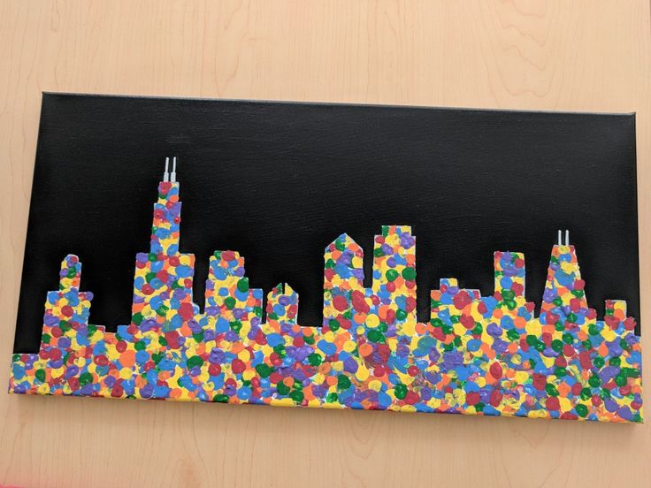 an art project made out of paper and colored confetti in the shape of a city